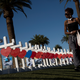 A woman walks past some of the 58 white crosses for the victims of the mass shooting Oct. 1, on the south end of the Las Vegas Strip, on Oct. 5, 2017. (Drew Angerer/Getty Images)